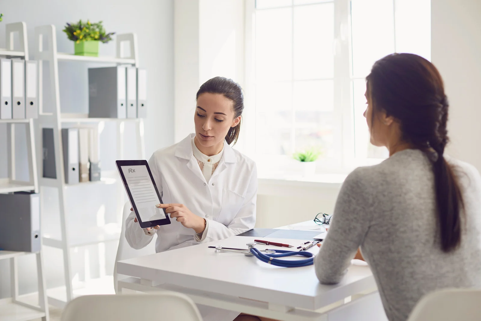 Woman patient visiting female doctor
